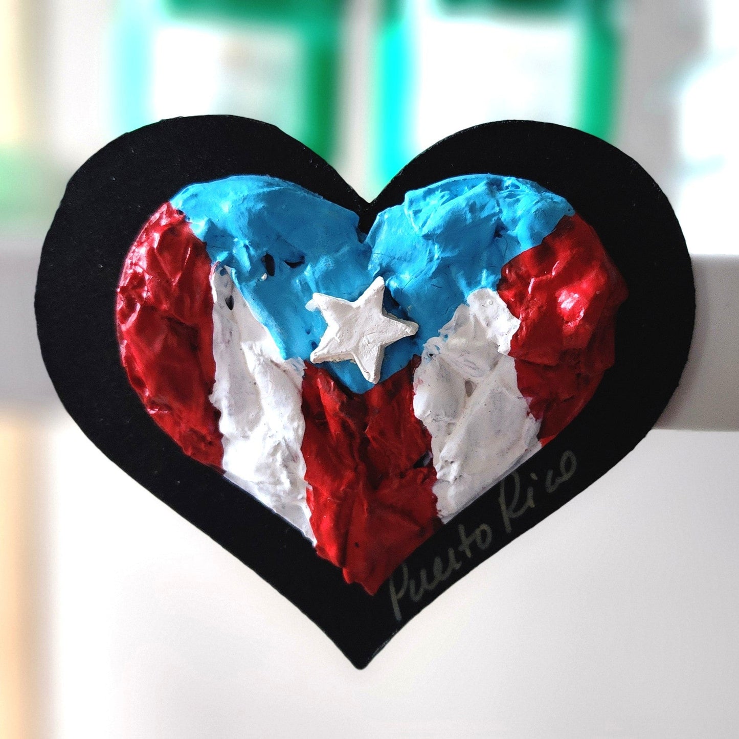 Heart-shaped object with red, white, and blue colors on a blurred background