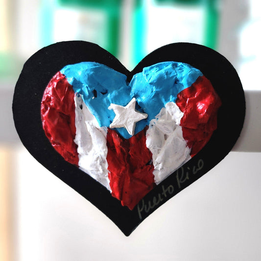Heart-shaped object with red, white, and blue colors on a blurred background