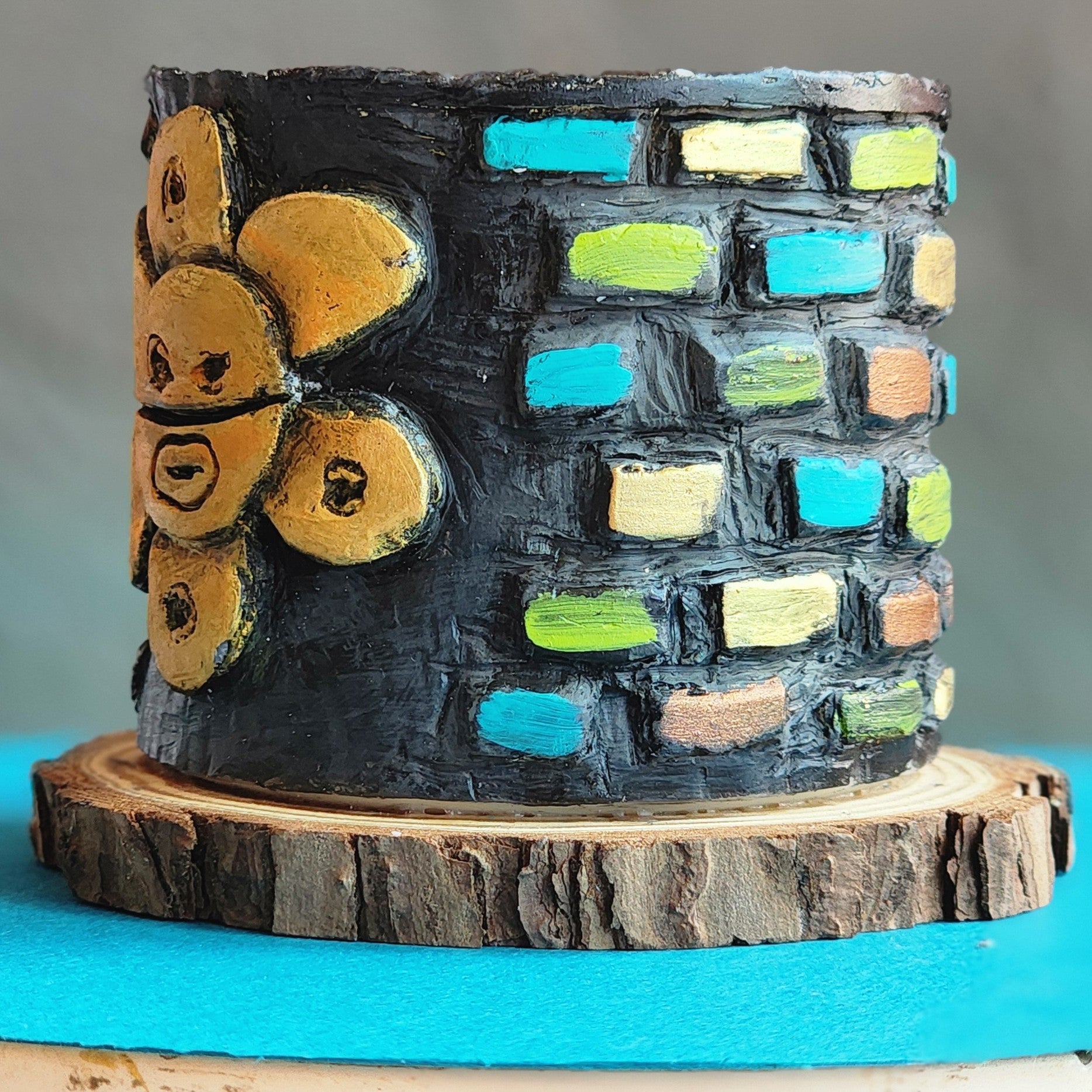 Decorative candle with Colorful brick-patterned in a gray background